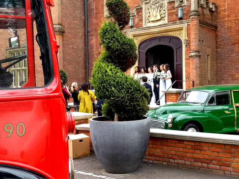 Latimer House, our red bus and a pristine Morris Traveller.